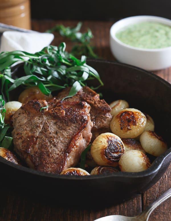 These American skillet lamb chops are made stove top in the skillet with browned cipollini onions. Topped with a fresh tarragon honey mustard sauce, they're a bright, refreshing and incredibly quick dinner!