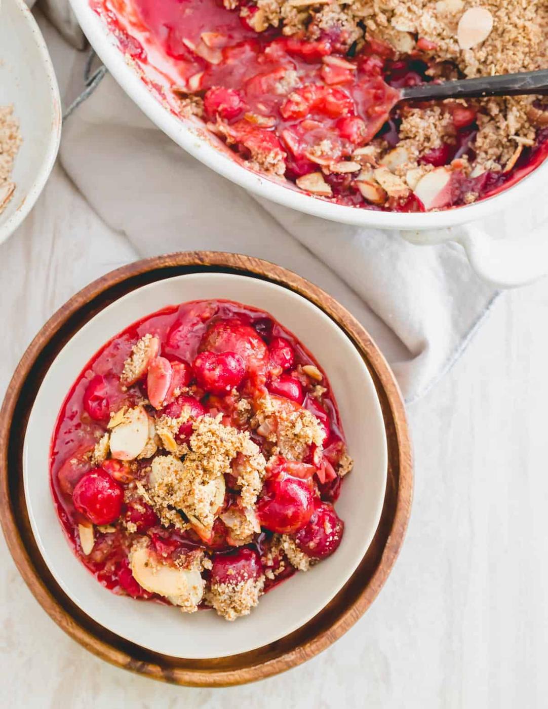 A serving of sour cherry crumble in a small bowl.