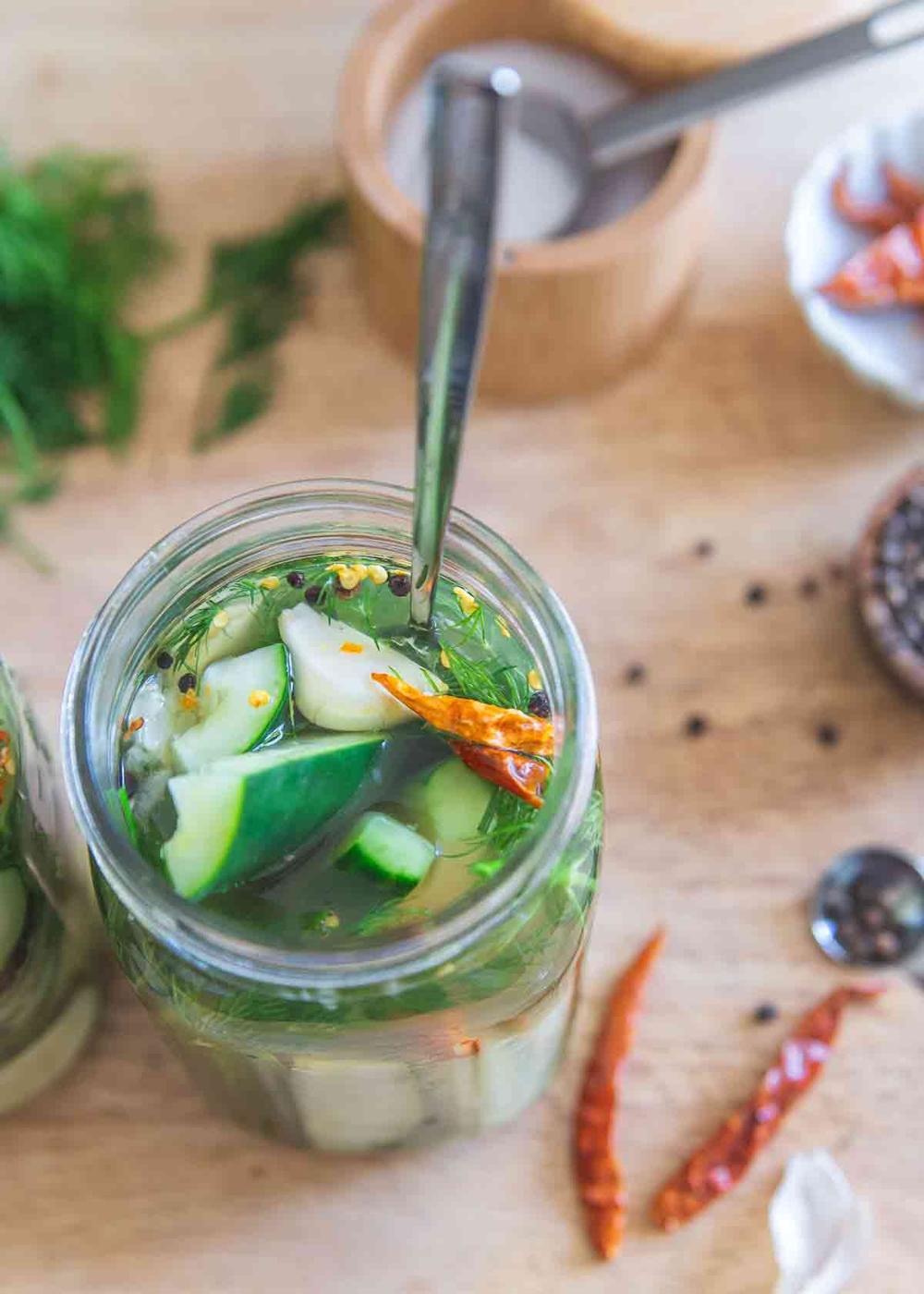 This recipe for garlic dill pickles with the option to make them spicy is quick and easy. You'll have tangy pickles ready to eat in just a few days!