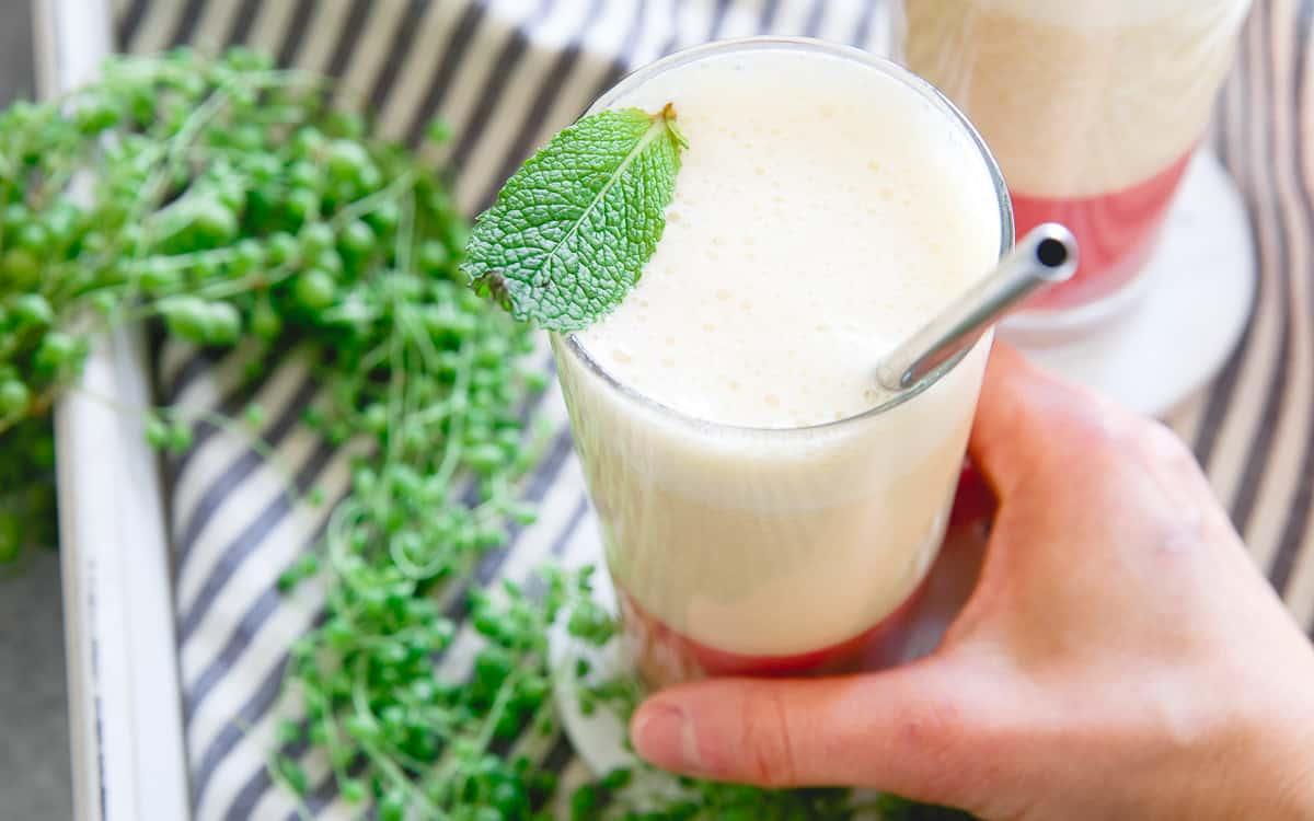 A simple layered smoothie with strawberry ginger puree and a protein packed banana peach top - it's refreshing and delicious!