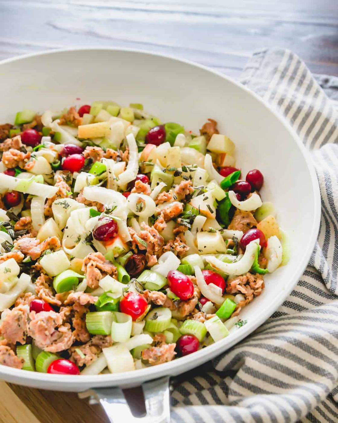 An easy filling of ground pork, cranberries, apples, leeks and fennel in the pan before stuffing the roasted delicata squash.