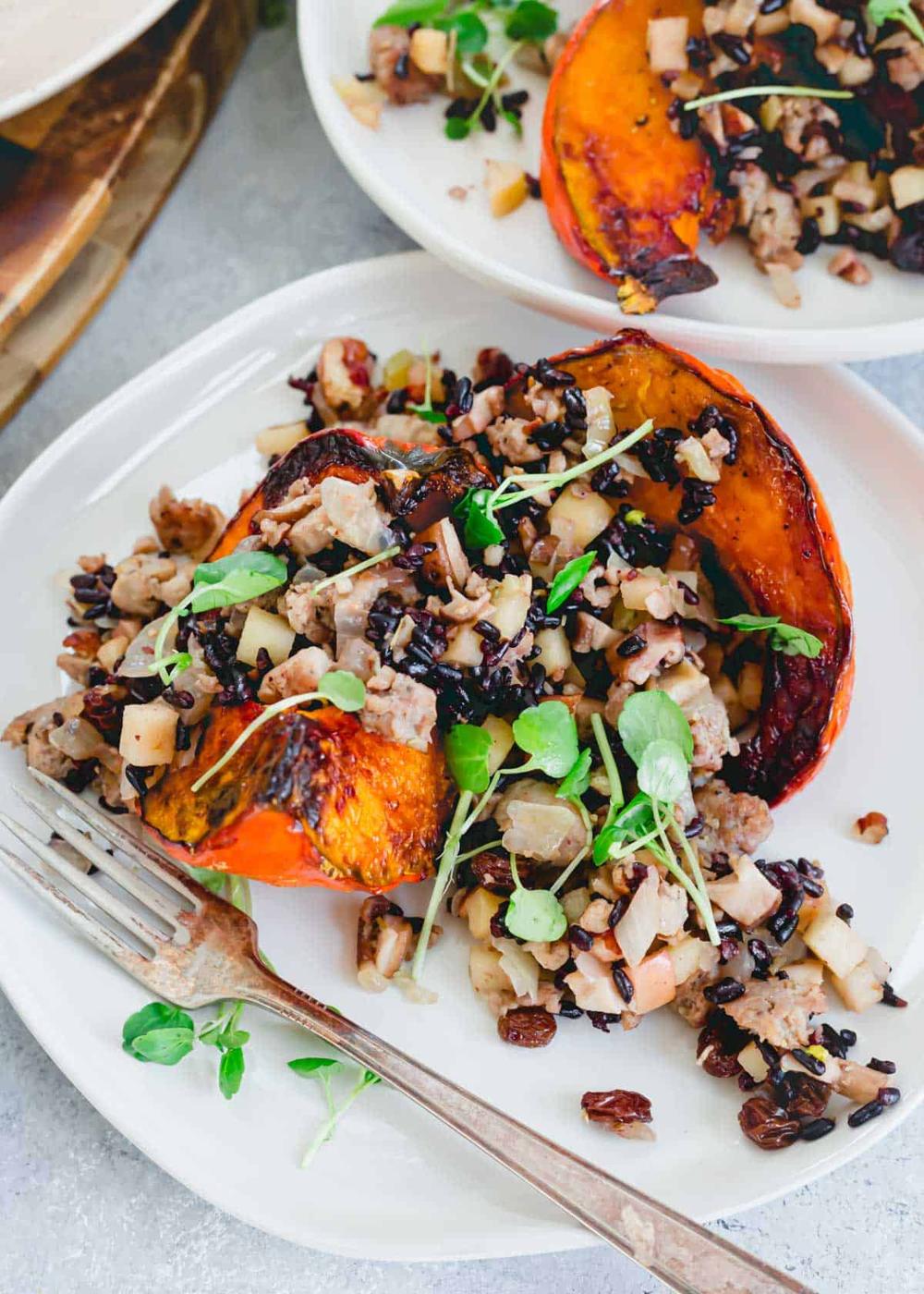 Stuffed red kuri squash recipe on a plate with a fork.