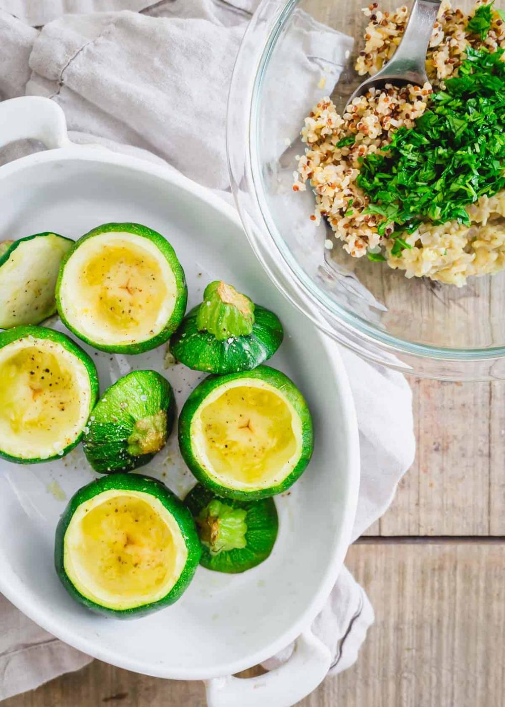 Baked round zucchini summer squash with olive oil, salt and pepper and quinoa stuffing on the side.