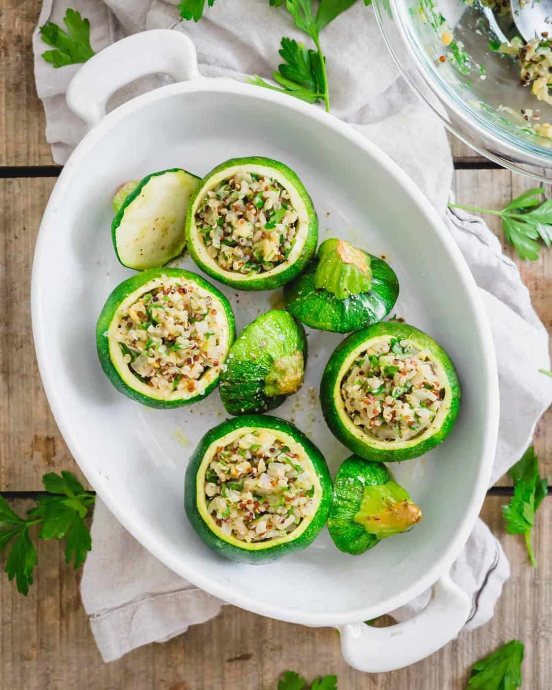 Baked round zucchini stuffed with quinoa, shallots, garlic and parsley.
