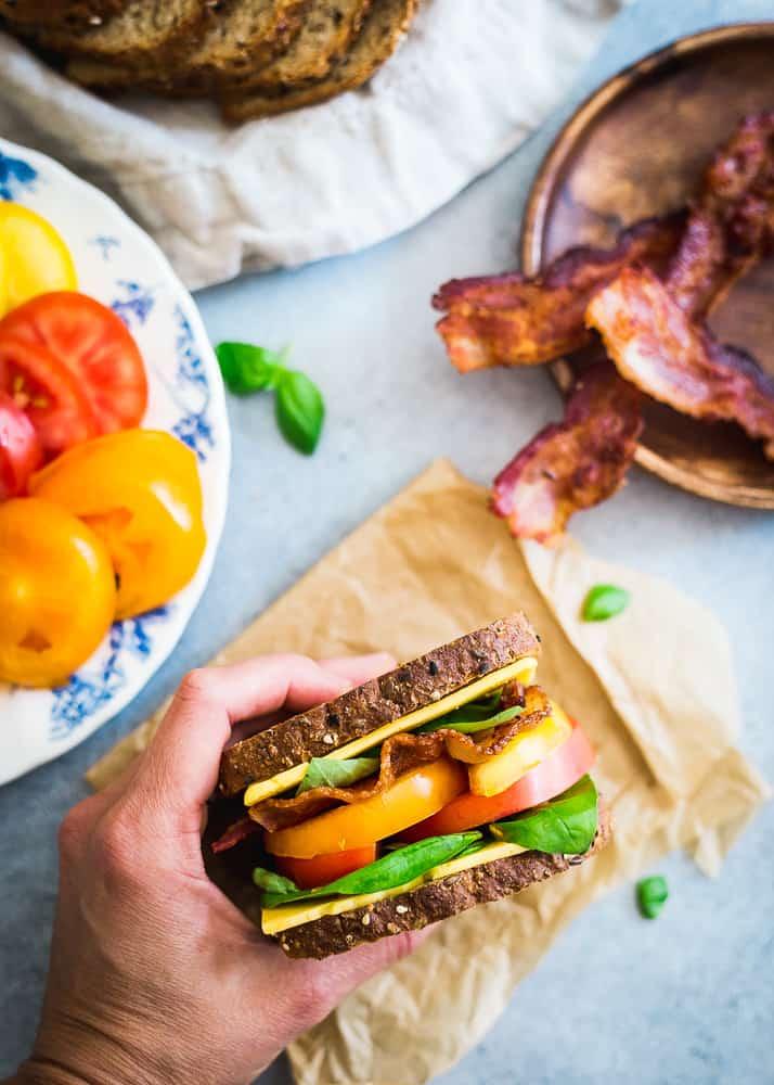 A summer inspired BLT with cheese on multigrain seeded bread is a delicious seasonal lunch.