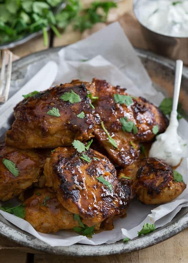 This sweet and spicy Indian chicken is marinated in yogurt and spices and finished with a sweet and sticky maple syrup glaze.
