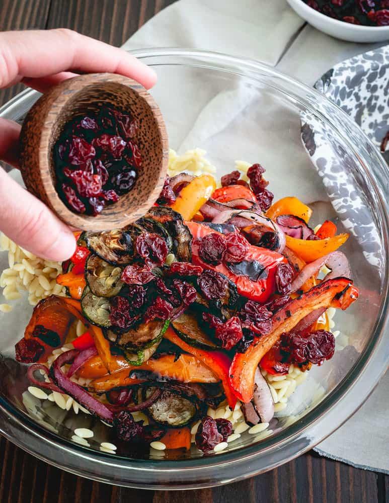 Tart cherries add a sweet bite to this summer vegetable orzo salad.