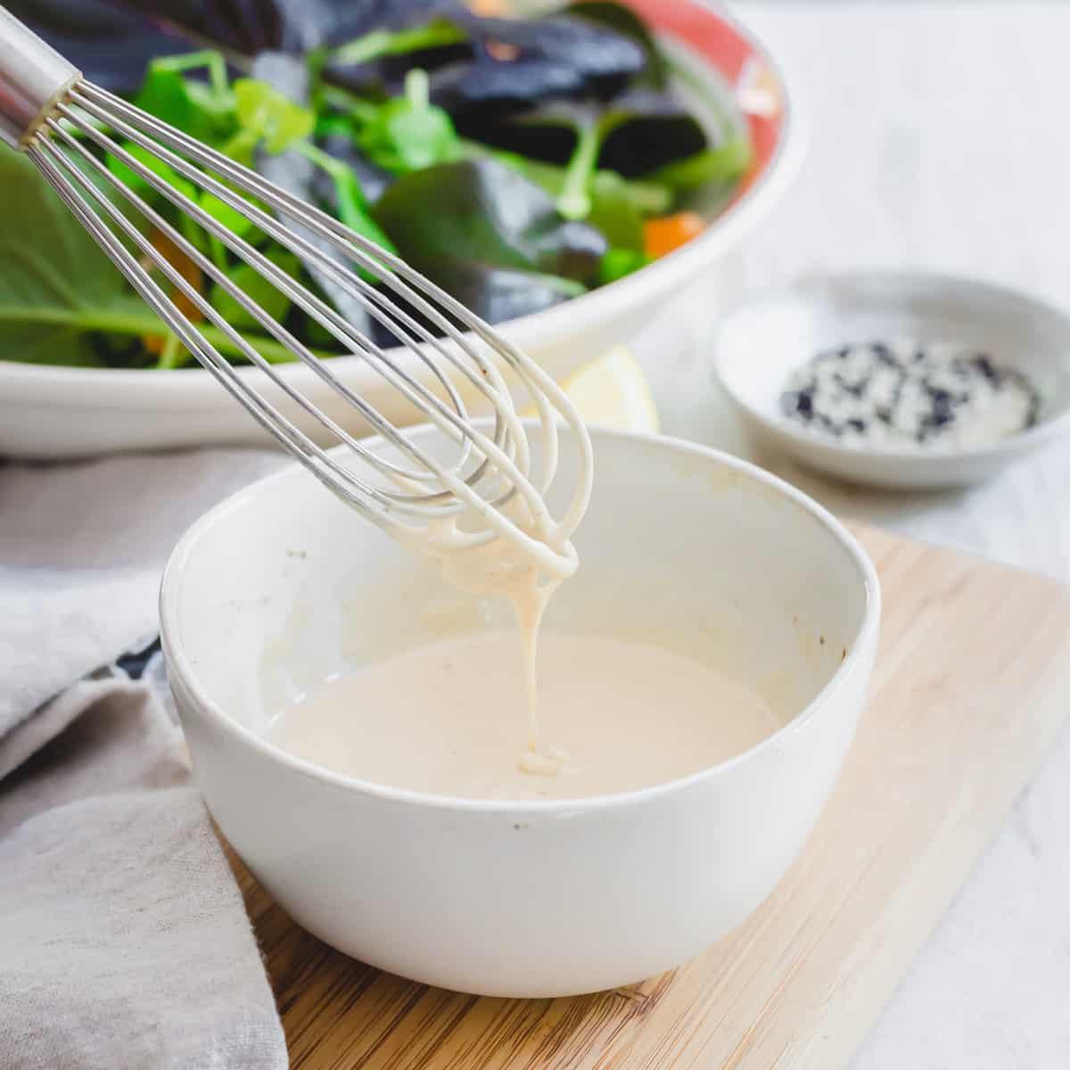 Creamy tahini dressing in a bowl.