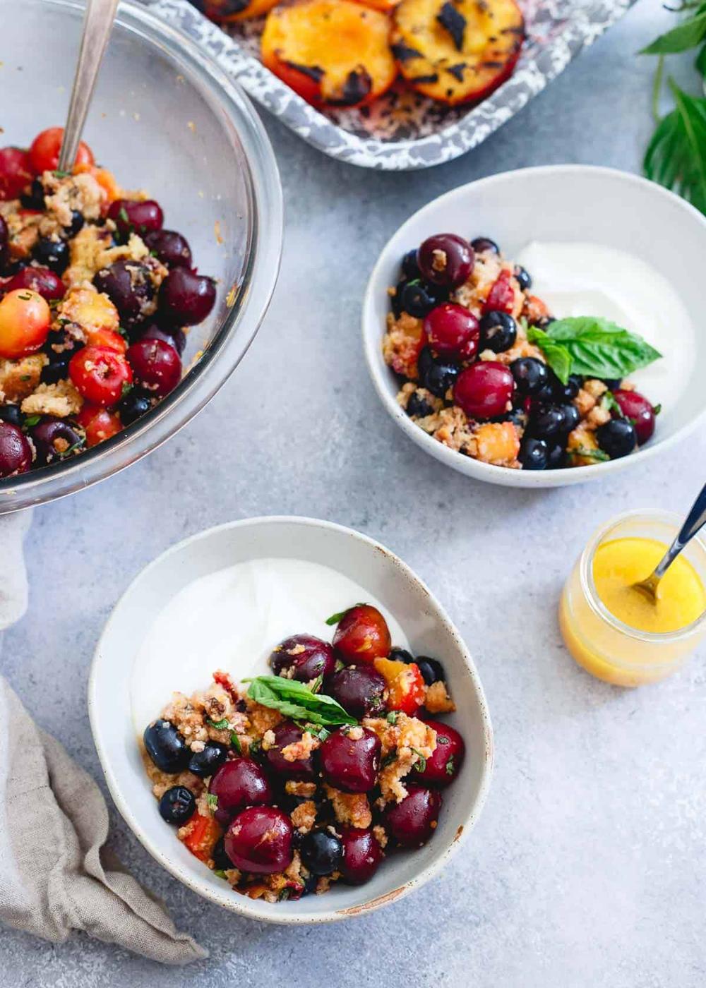 This summer fruit panzanella is full of sweet, ripe cherries, blueberries, grilled nectarines, toasted gluten-free blueberry muffins and a sweet citrus dressing. Spoon over yogurt, vanilla ice cream or eat as is for a light, summer-filled treat.