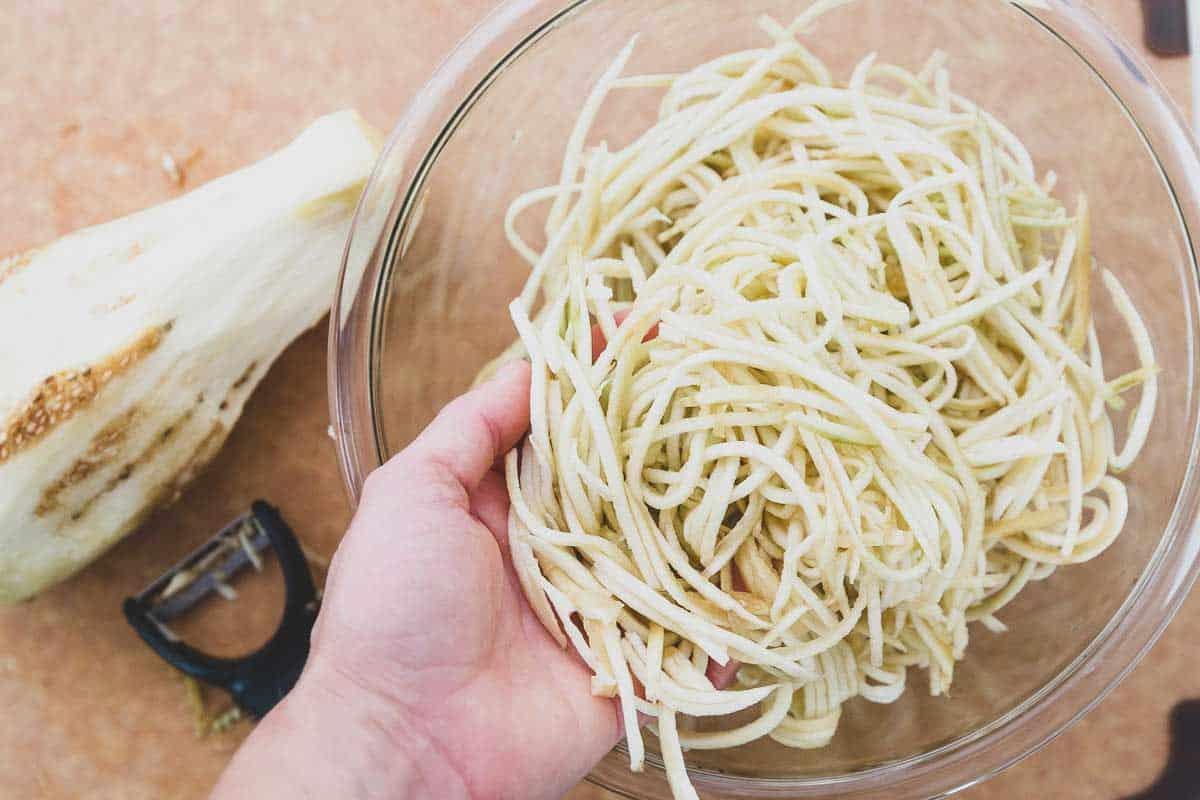 A simple julienne peeler makes easy noodles out of eggplant for a low carb pasta alternative.