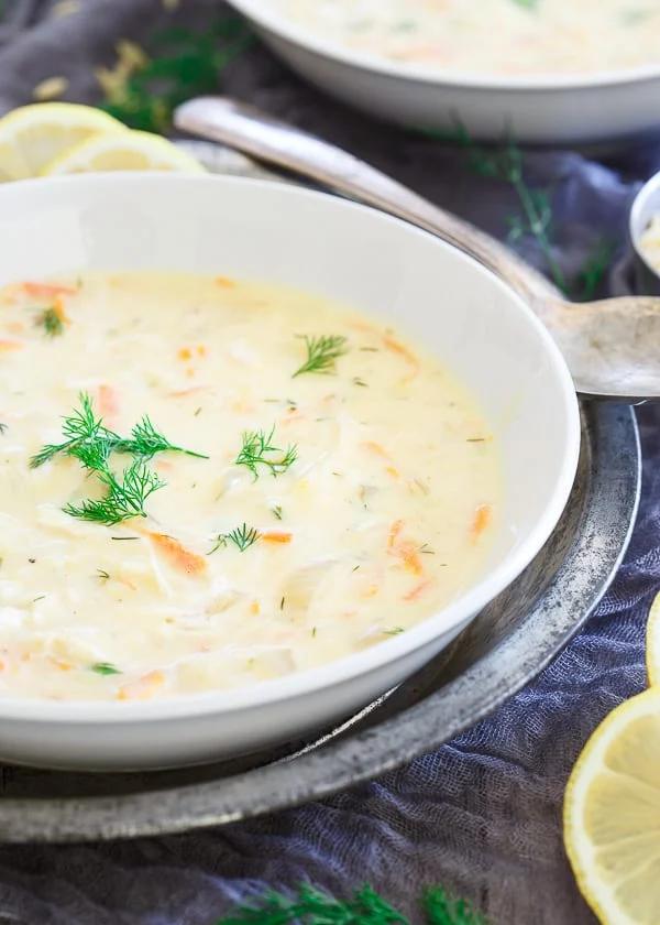 Leftover Thanksgiving Turkey orzo Soup in a white bowl next to a spoon.
