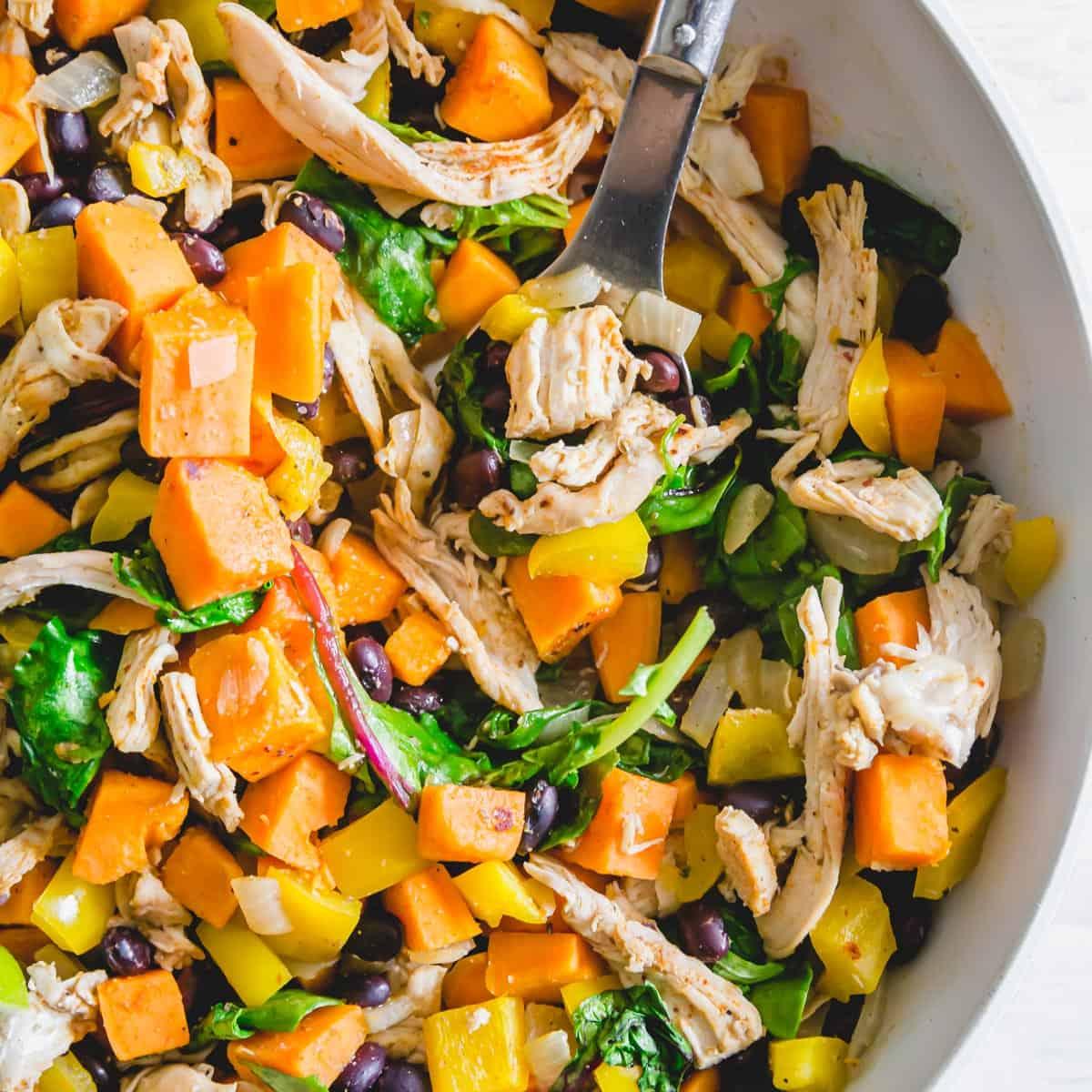 An easy meal perfect for using up leftover turkey from Thanksgiving with sweet potatoes, black beans, peppers, onions and baby greens.
