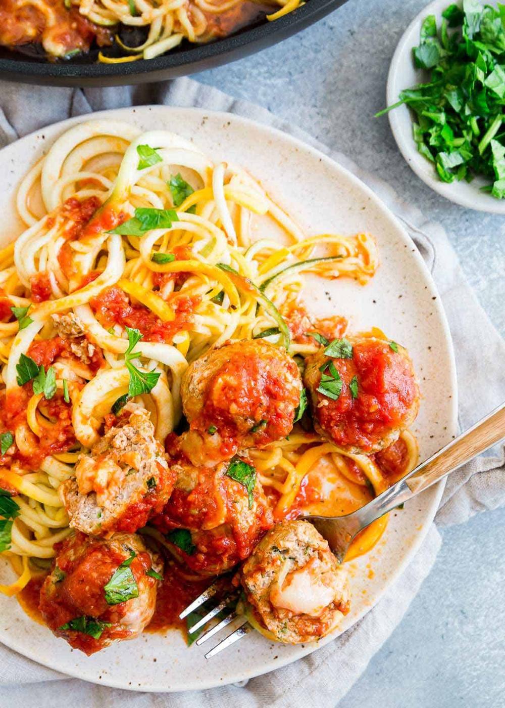 Try these easy and flavor packed turkey zucchini meatballs filled with gooey cheddar cheese and served with simple zucchini squash noodles in marinara sauce.