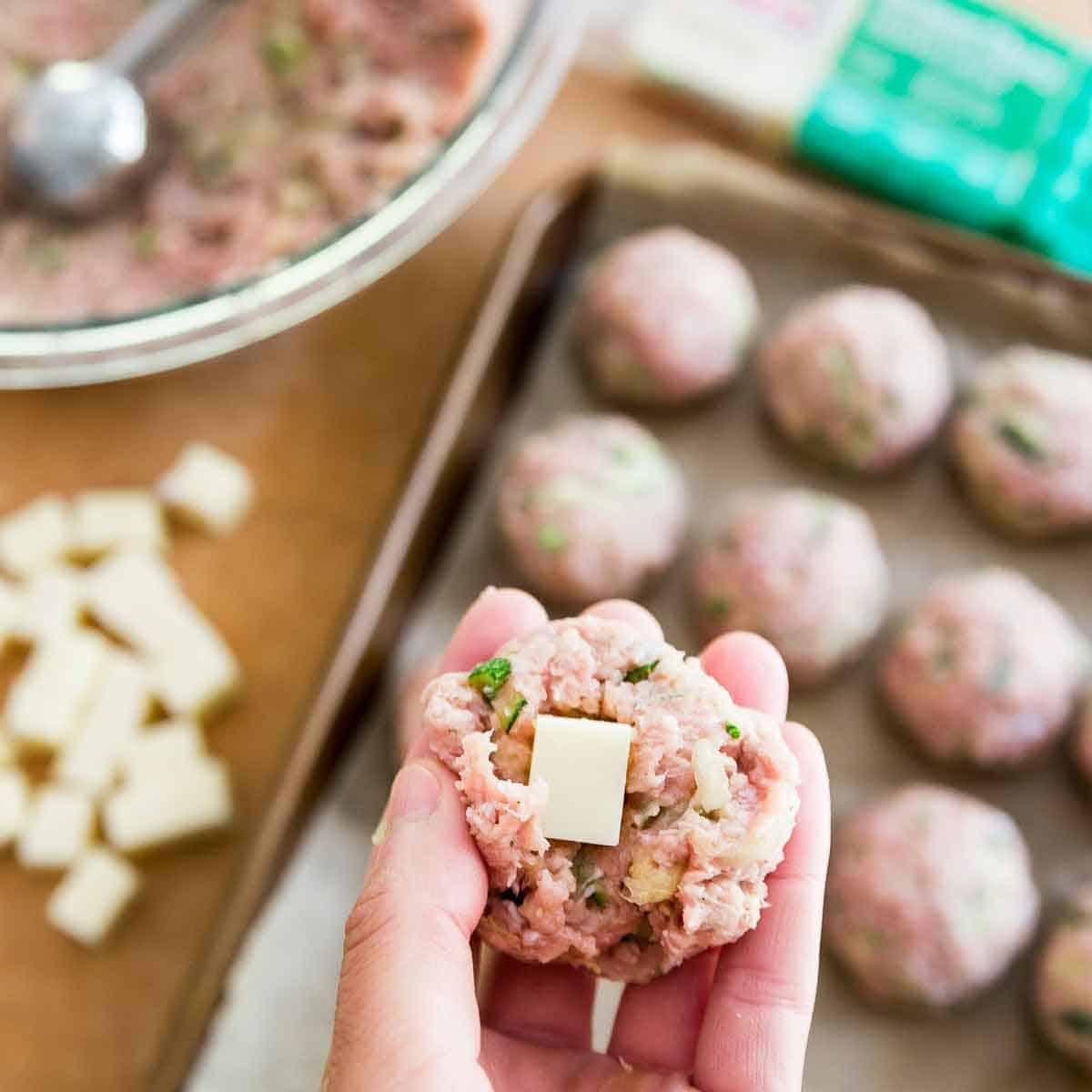 Italian seasoned turkey zucchini meatballs stuffed with cubes of cheddar cheese.