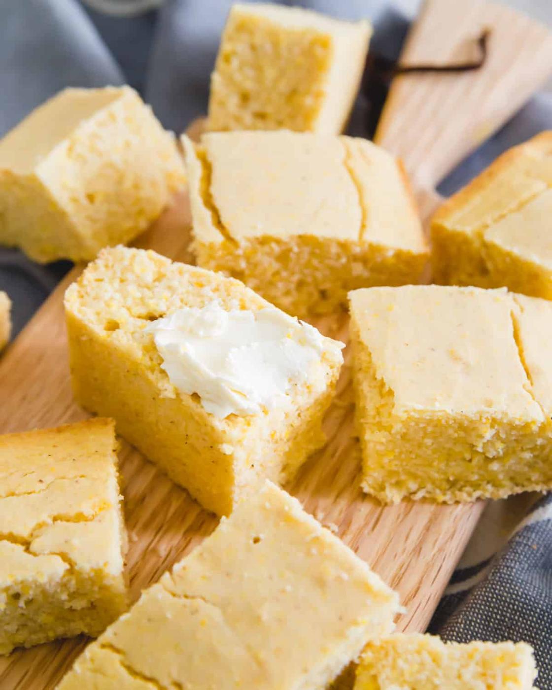 tender vegan and gluten-free cornbread recipe with a smear of soft butter