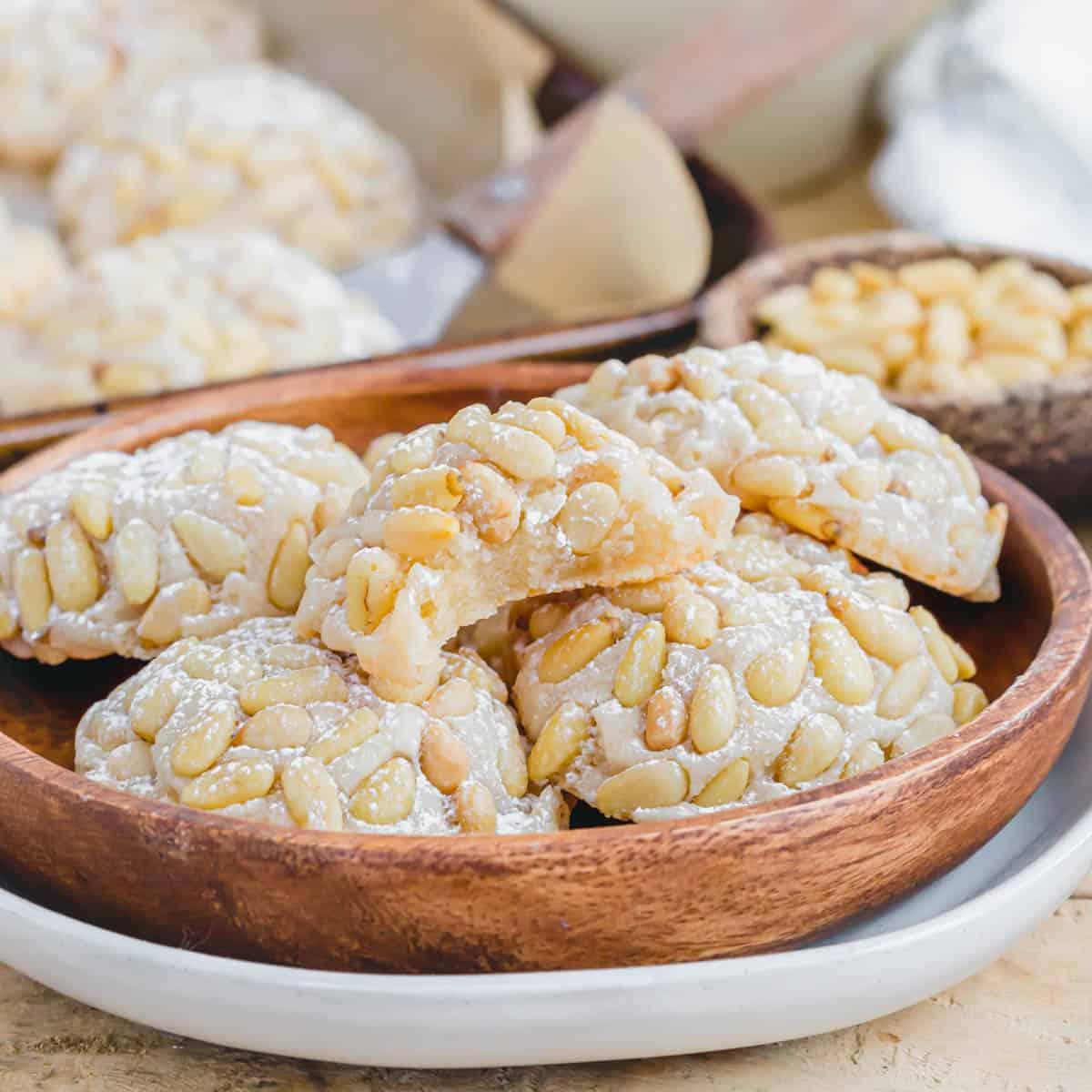 Showing the inside chewy almond paste center of a vegan pignoli cookie on a plate.