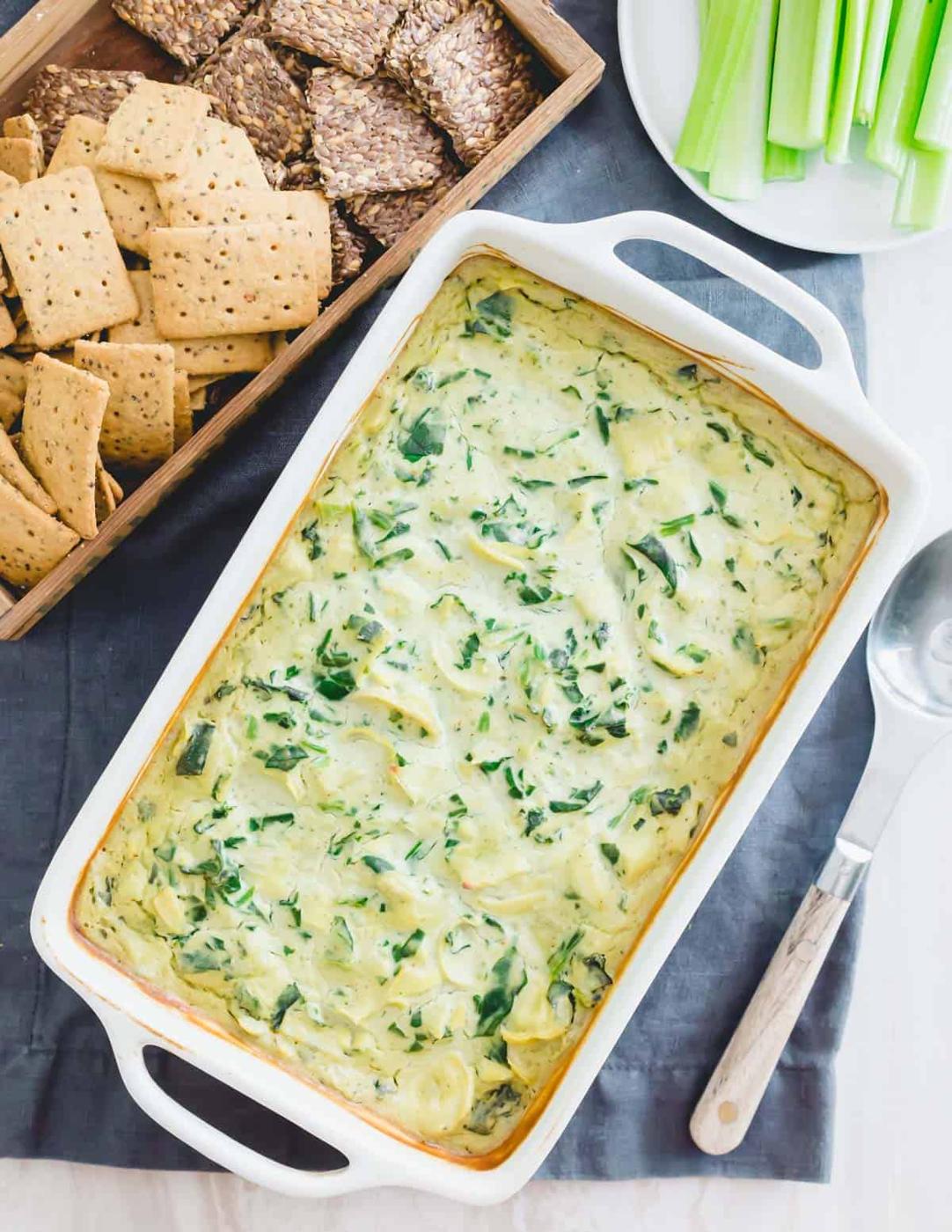 Decadent vegan spinach artichoke dip recipe hot out of the oven in a baking dish.