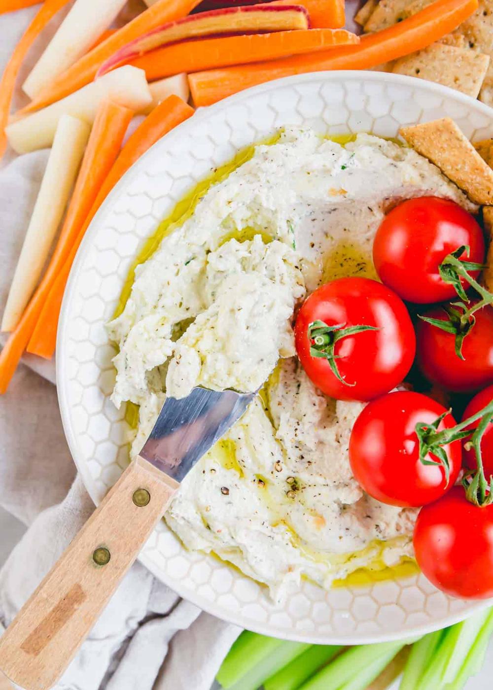 Garlic whipped goat cheese dip with olive oil and rosemary.