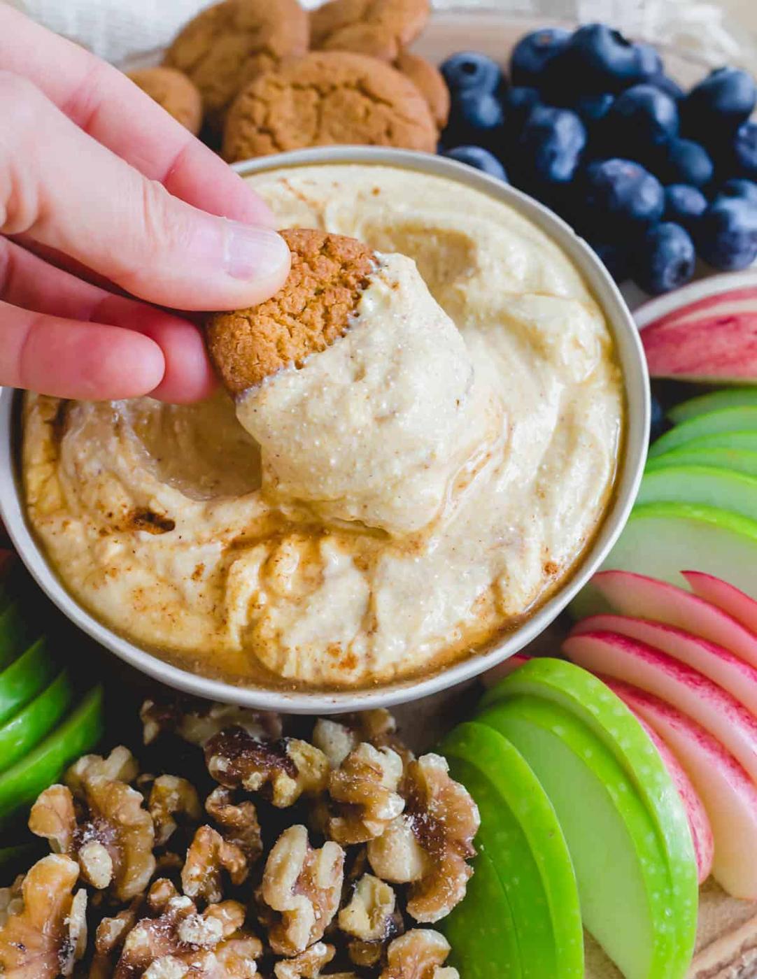 Dipping a gingersnap into sweet ricotta dip.
