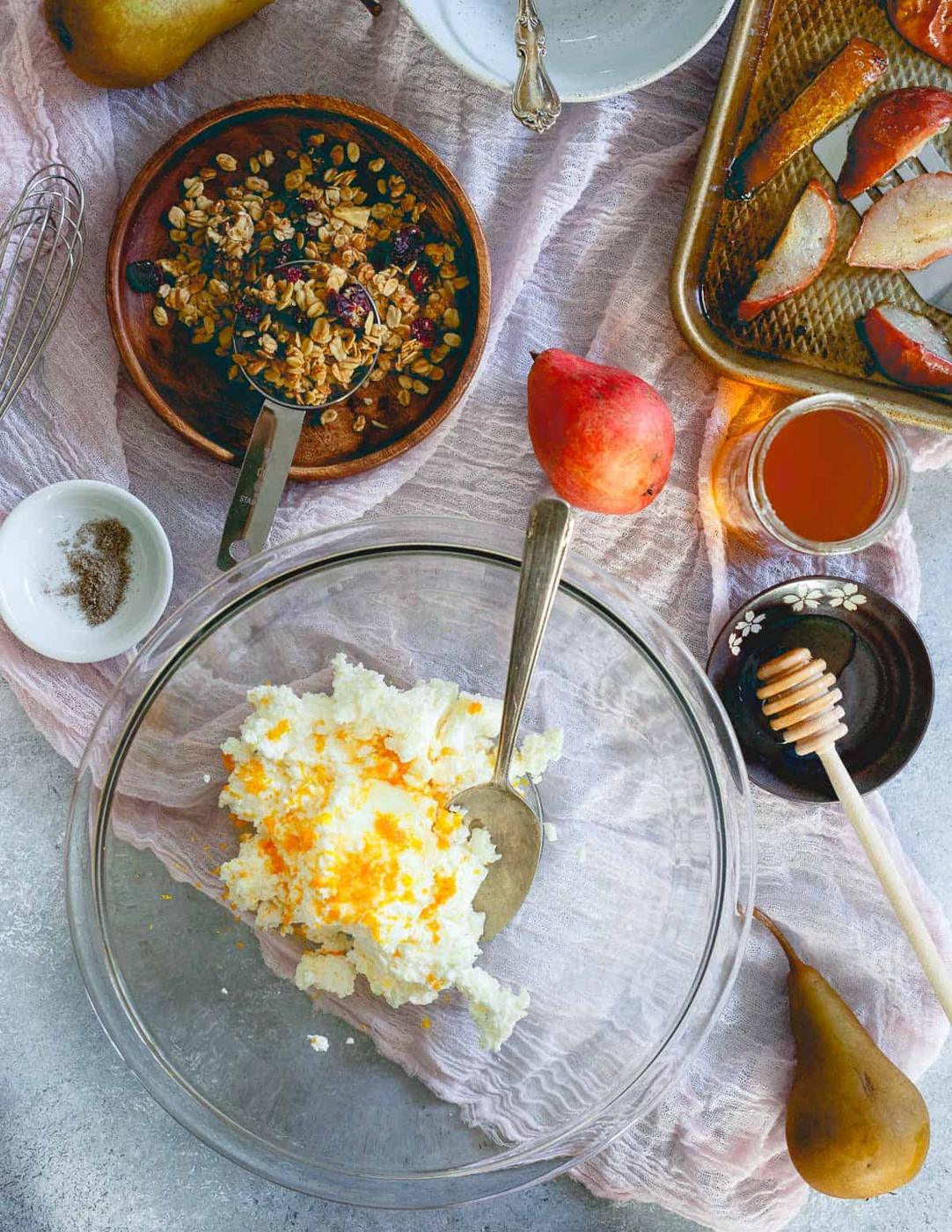 A lovely fall treat - hand whipped ricotta with honey, orange and cardamom topped with roasted pears and cranberry granola.