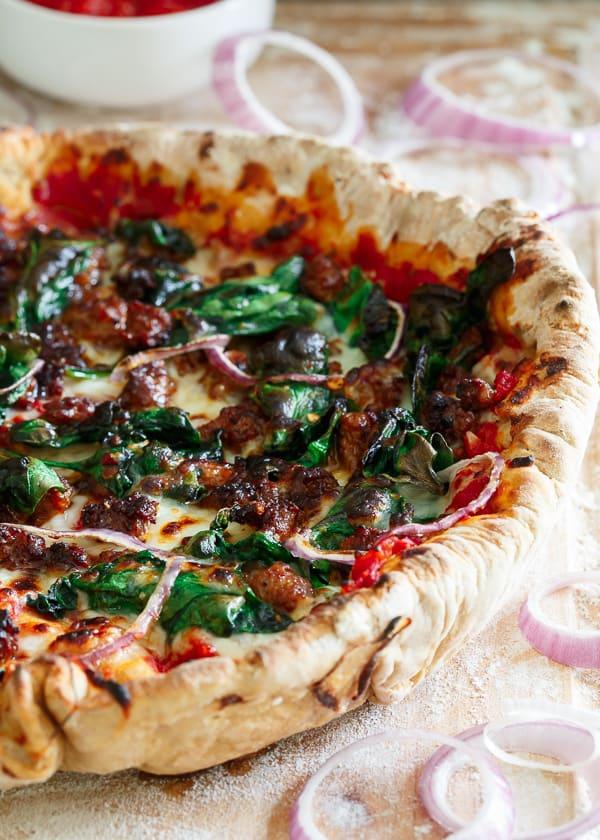 Somewhere between deep dish and regular pizza, this whole wheat chorizo spinach skillet pizza starts off with a quick homemade tomato sauce and is topped with plenty of fresh cheese, spicy chorizo, spinach and onions.