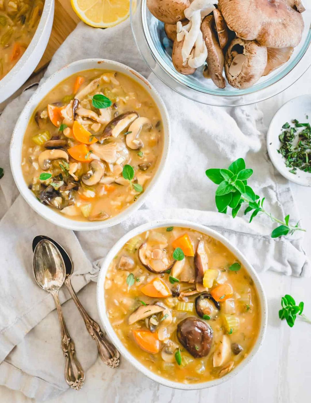 Wild mushroom soup in white bowls.