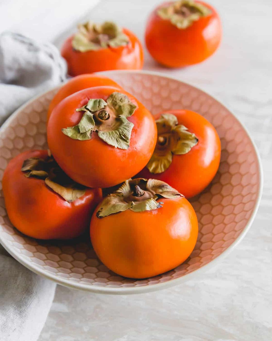 Fuyu persimmons in a bowl to make persimmon jam