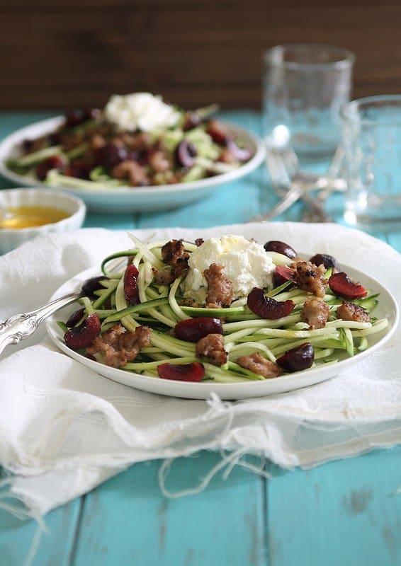 Italian sausage, ripe summer cherries a creamy ricotta combined with zucchini noodles in this lighter summer dish.