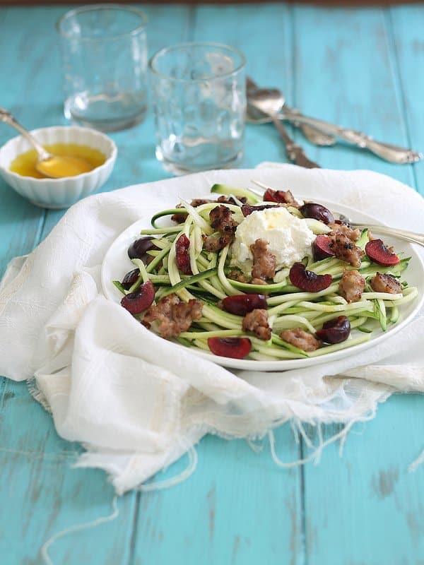 Zucchini noodles are a healthy alternative to traditional pasta in this dish with Italian sausage, cherries and ricotta.