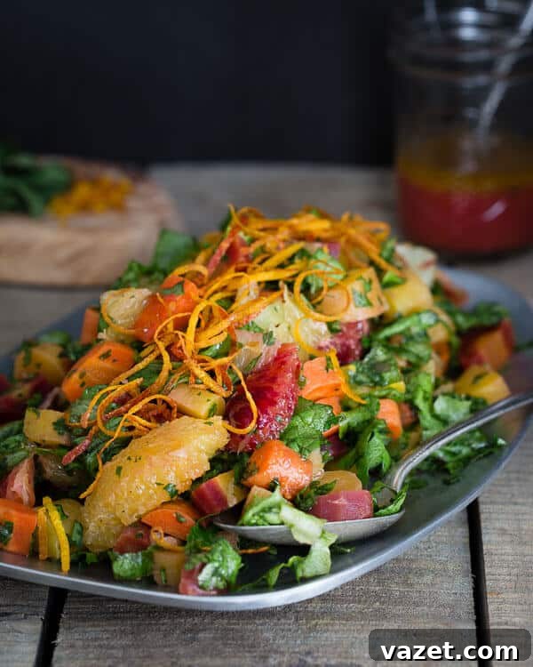 A beautifully presented chopped carrot citrus salad with roasted rainbow carrots, blood oranges, and Meyer lemons, glistening with a vibrant citrus mustard vinaigrette, showcasing the best of winter's bounty.