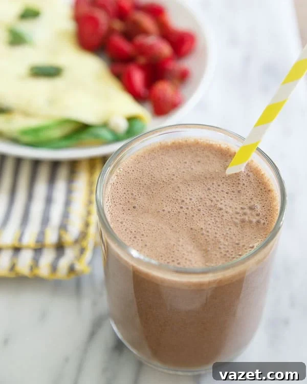 Close-up of a chocolate cashew butter smoothie with banana slices.