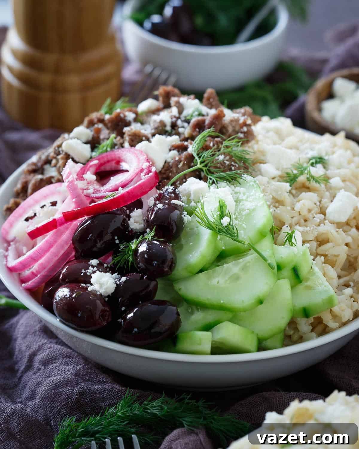 Savor the Flavors of Greece with Our Wholesome Rice Bowls Vibrant Greek Brown Rice Bowl featuring perfectly cooked brown rice topped with seasoned lamb and fresh toppings