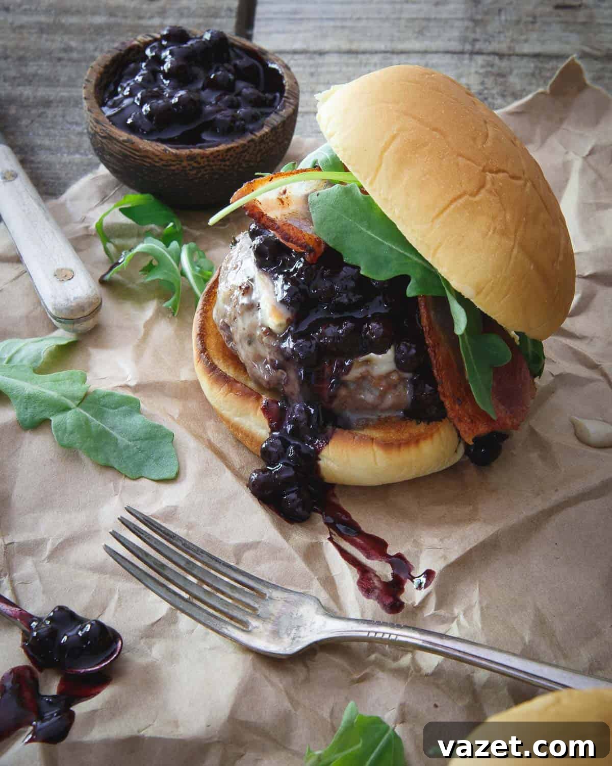 Sweet and tangy blueberry BBQ sauce gets slathered on this brie burger with crispy bacon and arugula. Sweet and tangy blueberry BBQ sauce gets slathered on this brie burger with crispy bacon and arugula.