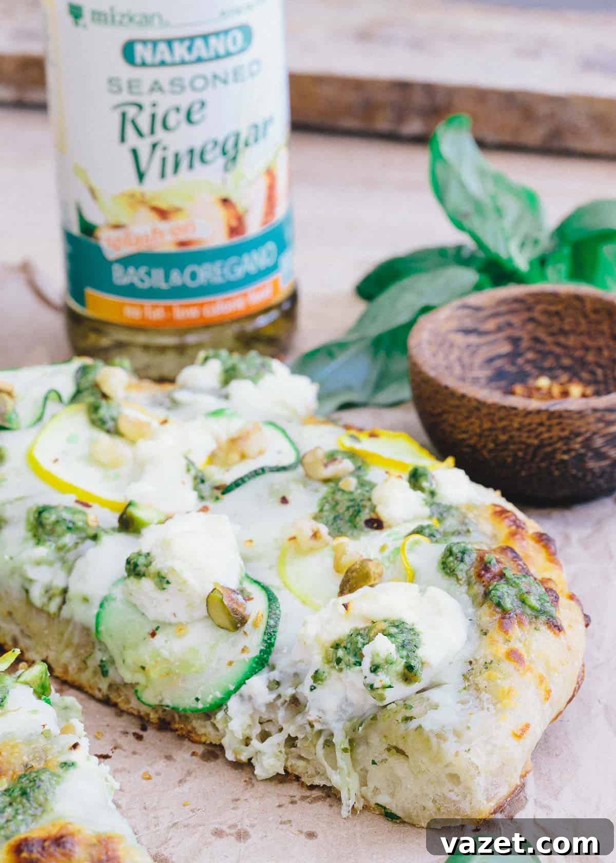 This skillet zucchini pesto pizza is made with Nakano basil and oregano rice vinegar for a tangy twist to traditional pesto. This skillet zucchini pesto pizza is made with Nakano basil and oregano rice vinegar for a tangy twist to traditional pesto.
