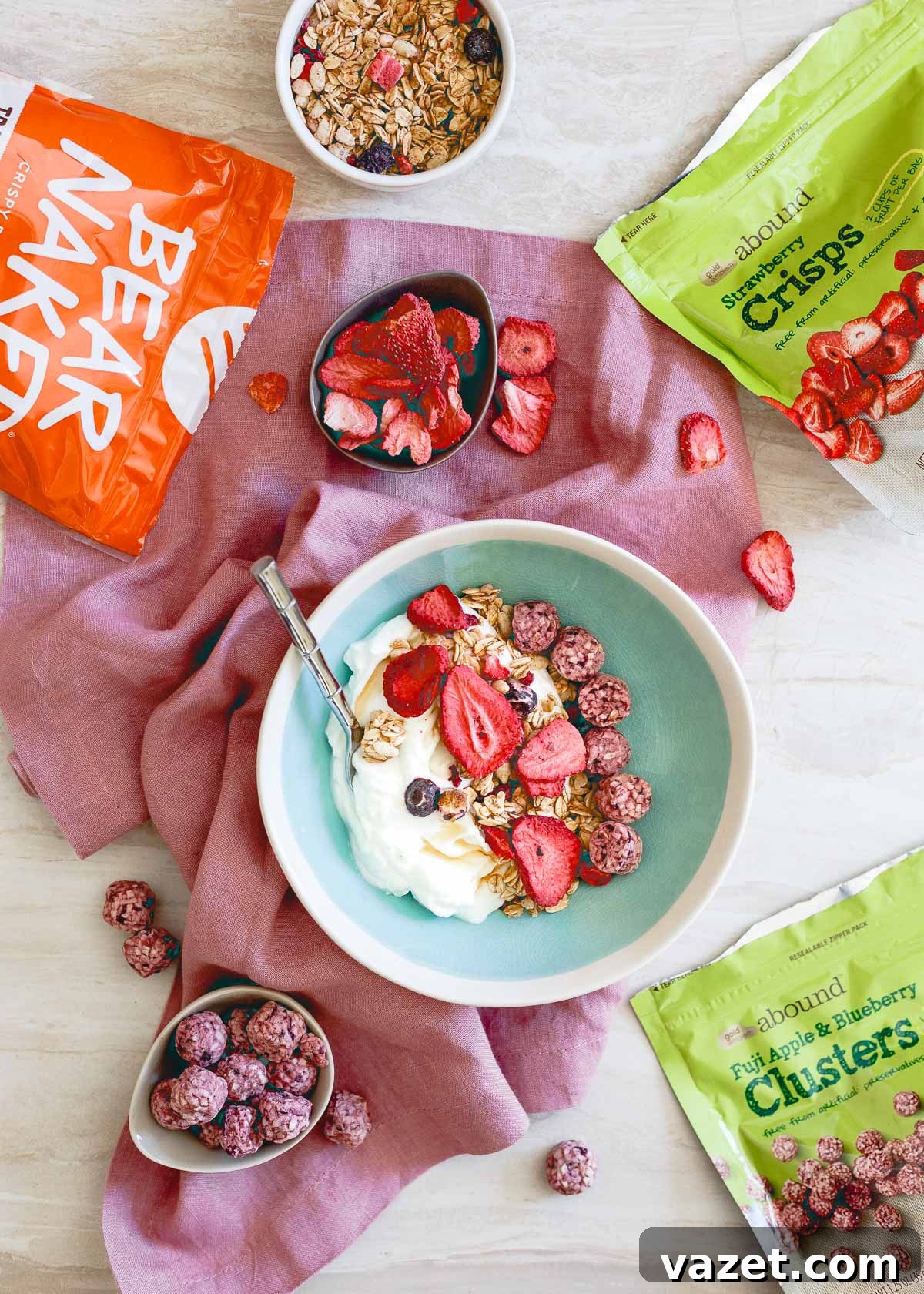 A healthy sweet snack idea featuring plain Greek yogurt, colorful freeze-dried fruit, and crunchy granola, perfect for afternoon sweet cravings from CVS.