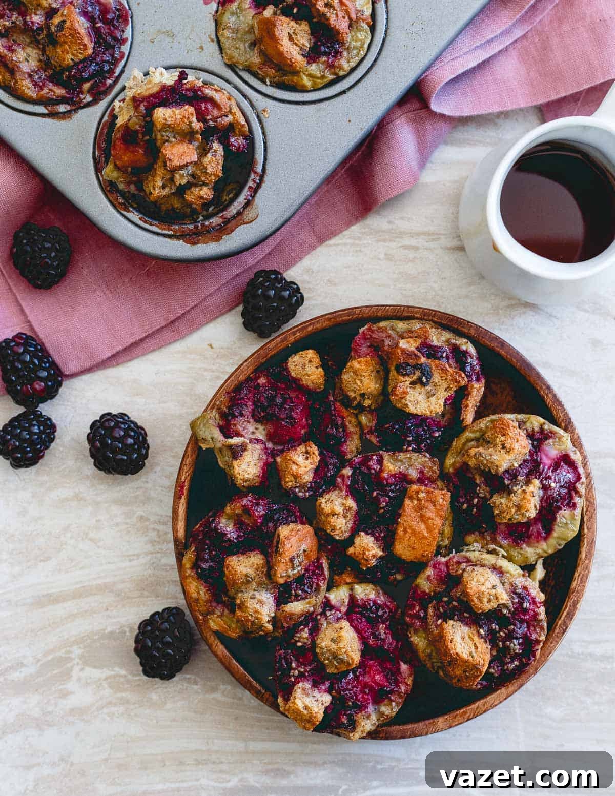 Close-up of baked blackberry ginger French toast bites in a mini-muffin tin, showcasing their golden brown edges.