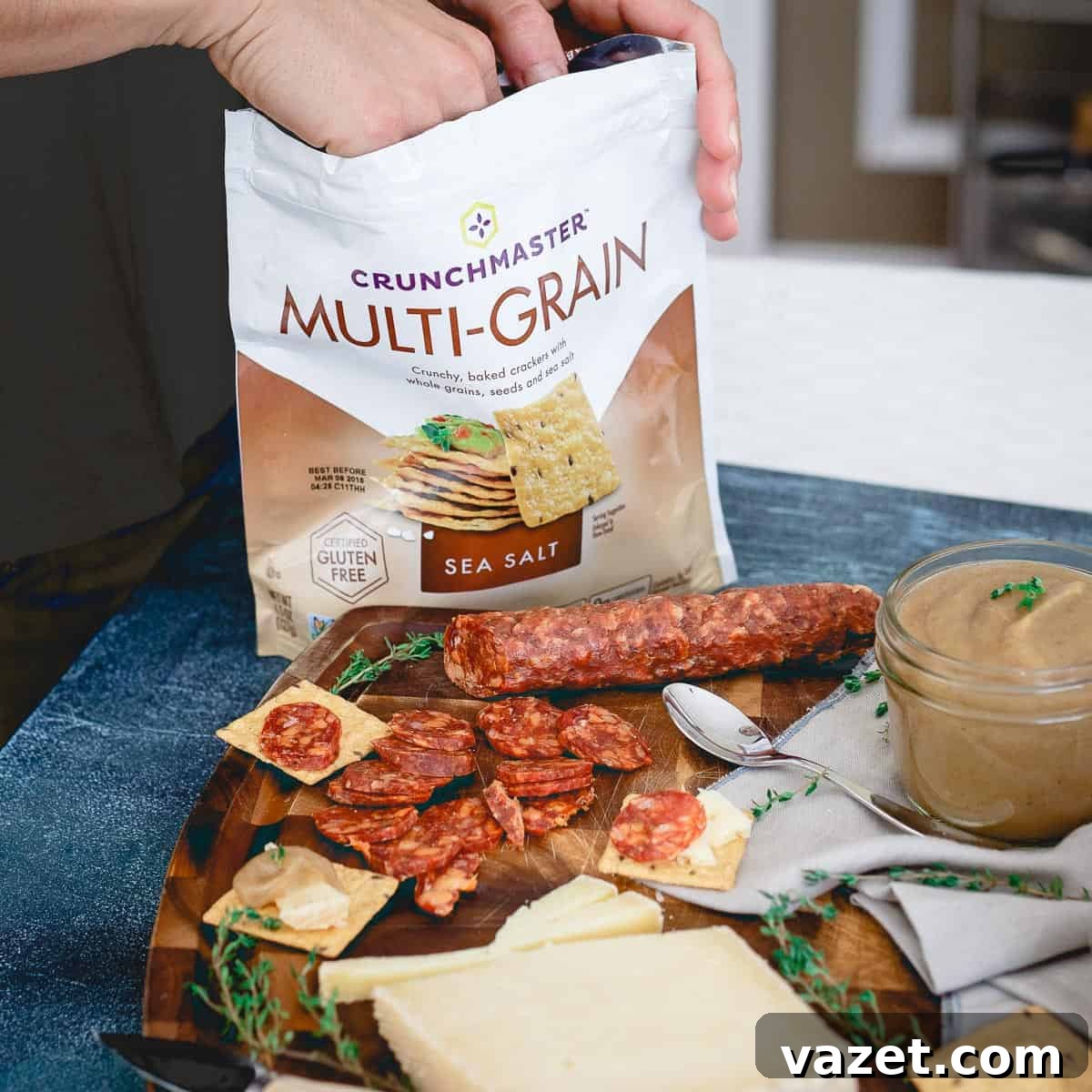 Crunchmaster multi-grain crackers are the perfect crunchy addition to a cheese, charcuterie, and pear apple butter spread.