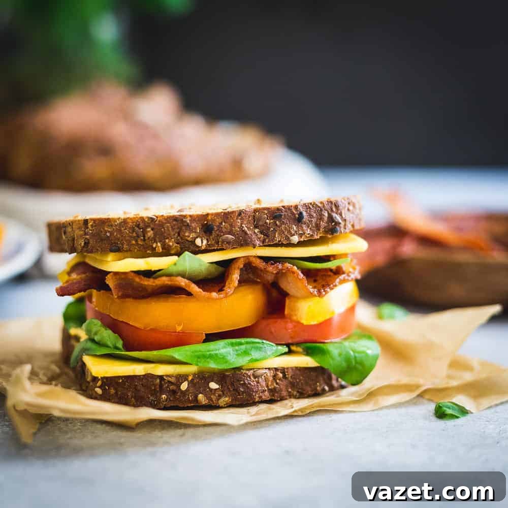 This BLTC sandwich draws inspiration from all the delicious late summer produce using heirloom tomatoes and fresh basil for a seasonal twist to the classic on seedy multigrain bread. This BLTC sandwich draws inspiration from all the delicious late summer produce using heirloom tomatoes and fresh basil for a seasonal twist to the classic on seedy multigrain bread.