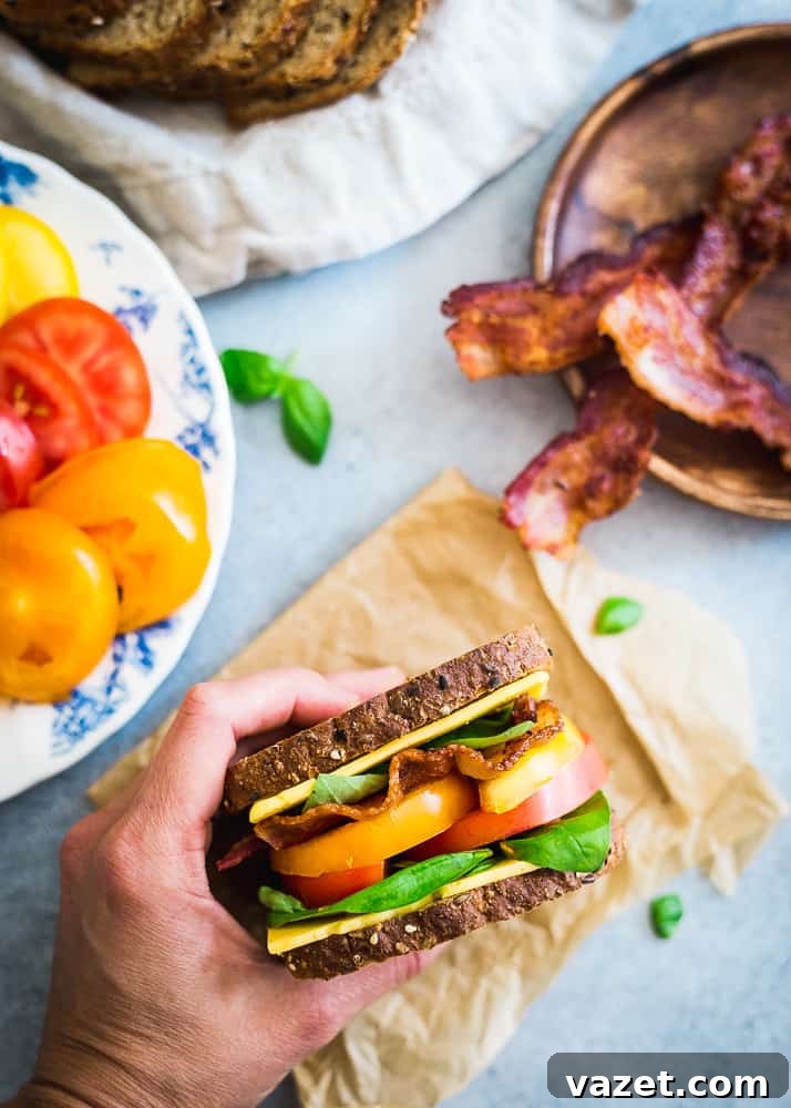 A summer inspired BLT with cheese on multigrain seeded bread is a delicious seasonal lunch. A summer inspired BLT with cheese on multigrain seeded bread is a delicious seasonal lunch.