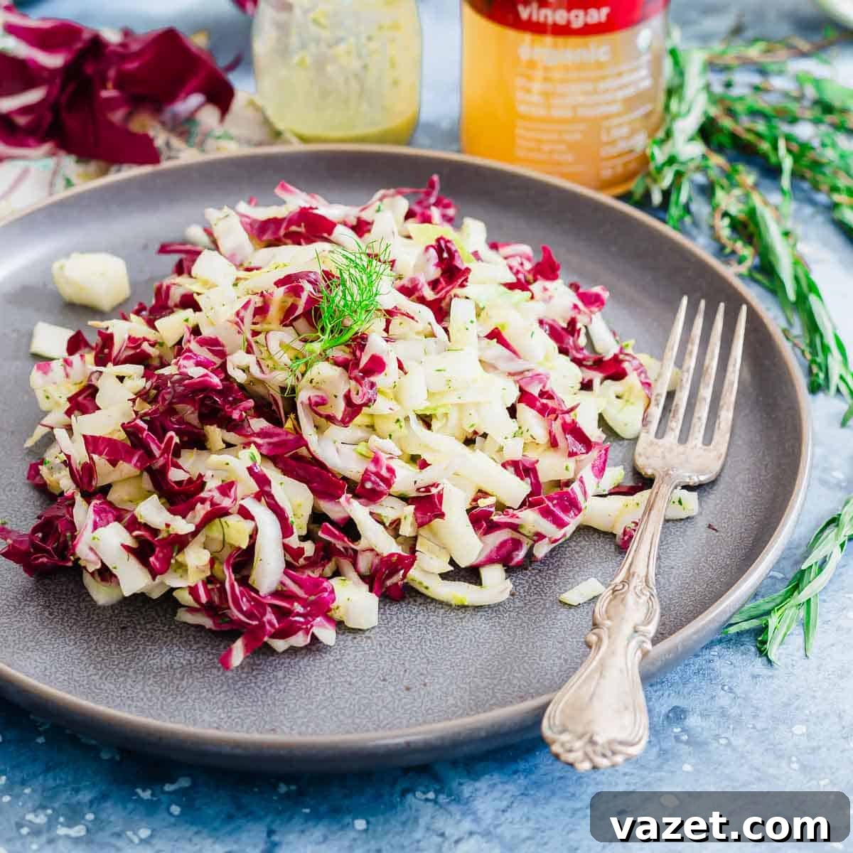 Chopped endive salad on a plate with a fork.