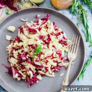 Endive, radicchio and fennel salad on a blue plate.
