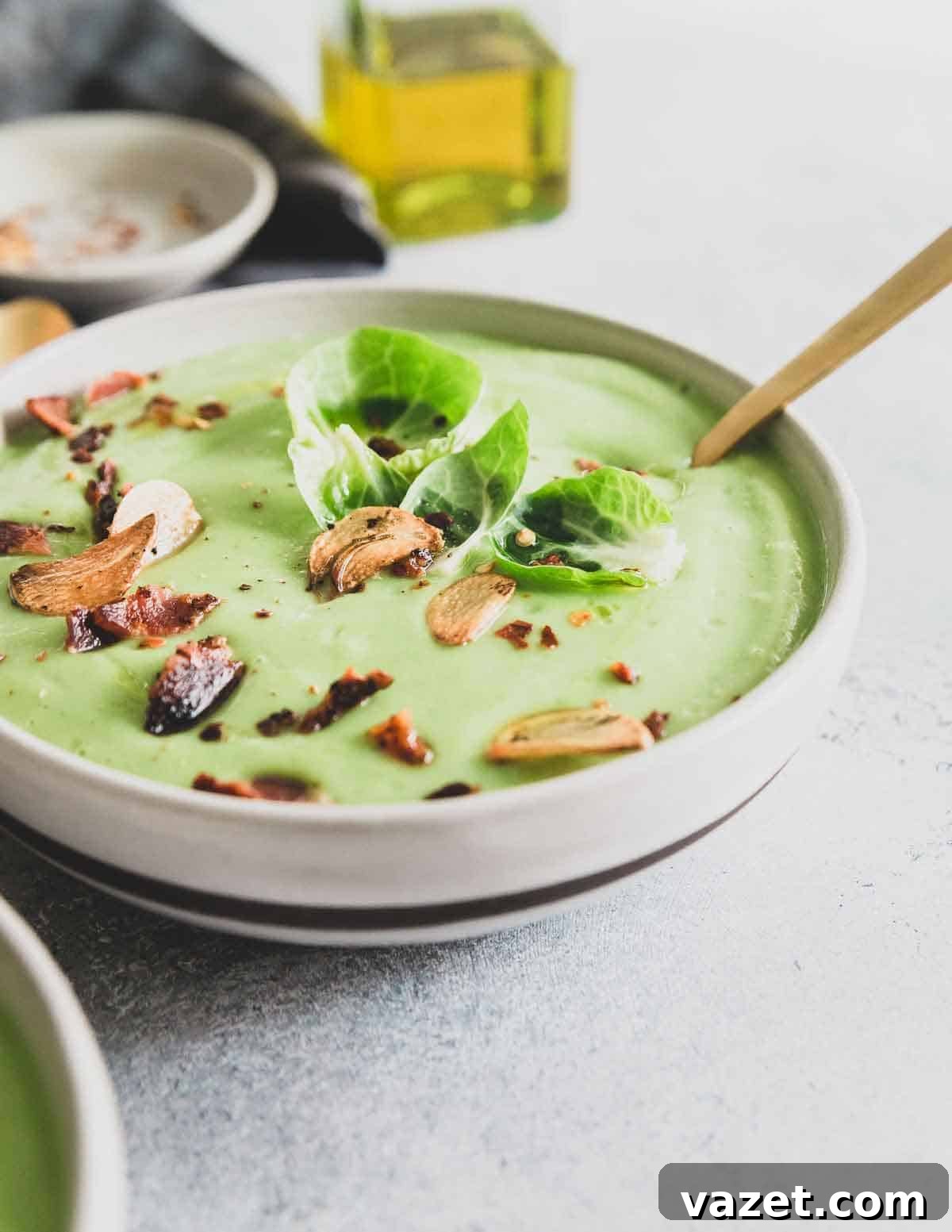 A creamy Brussels sprout soup packed with lots of garlic flavor and garnished with crispy bacon and fried garlic chips.