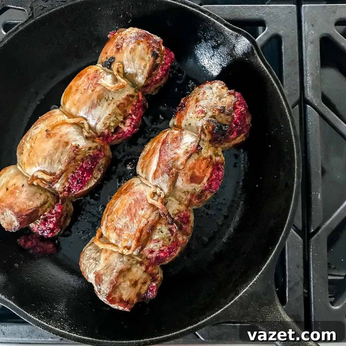 Pan seared rolled and tied lamb stuffed with bright cranberry pesto, prepared for roasting.