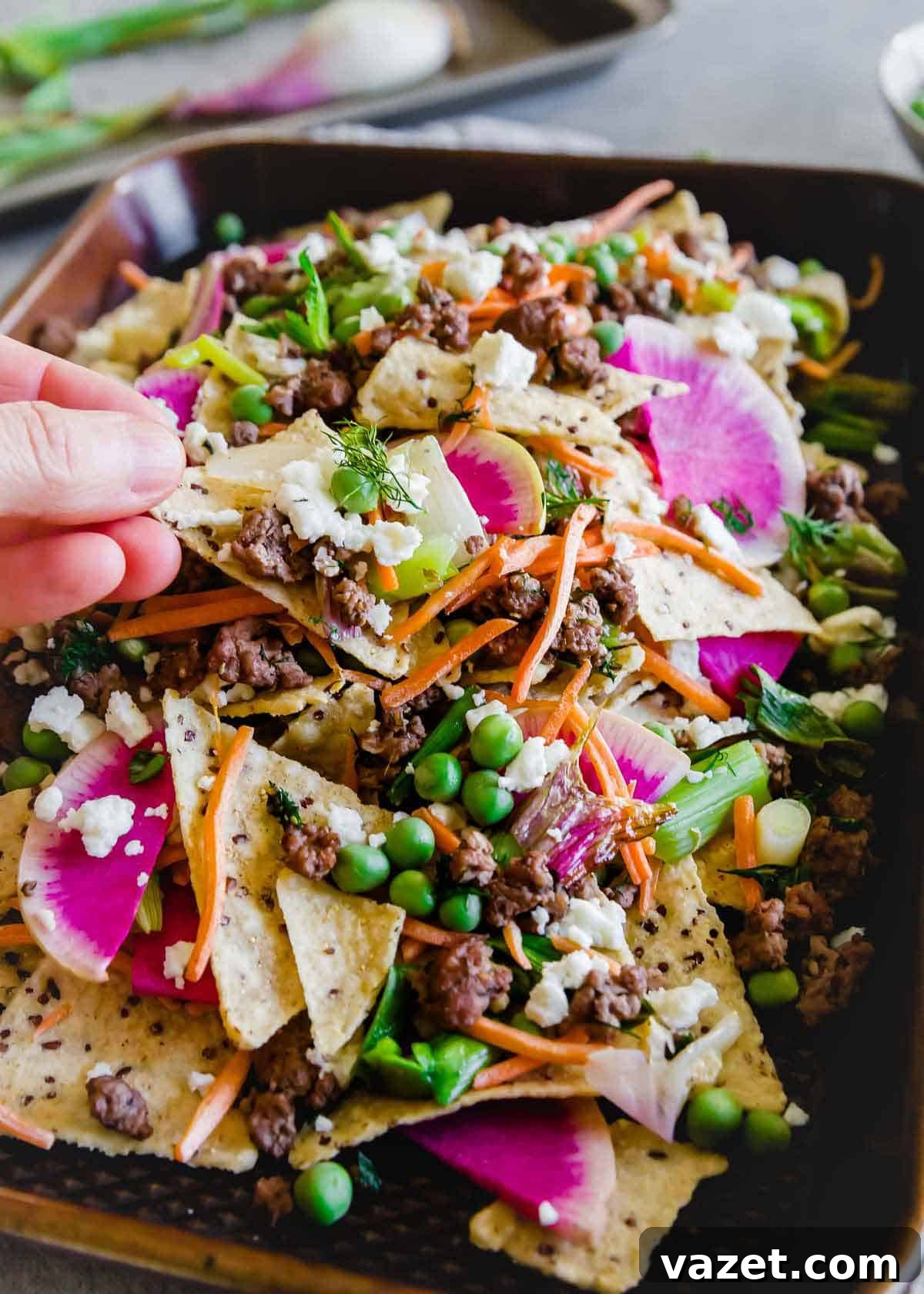 Loaded Spring Lamb Nachos 6 A fun, seasonal spin on traditional nachos, these feature ground lamb seasoned with dill and oregano, paired with an abundance of fresh spring vegetables for a unique flavor profile.