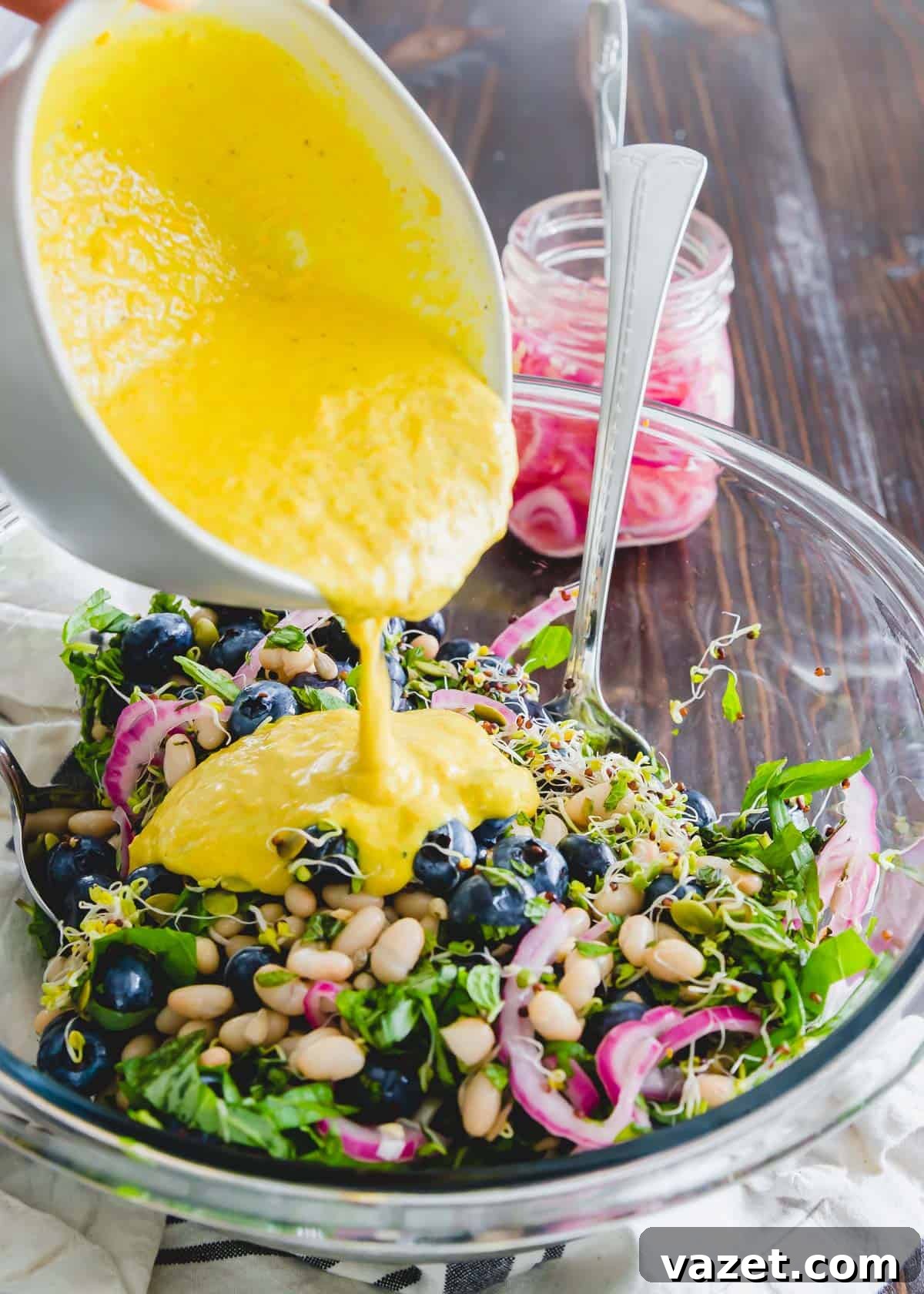 This blueberry white bean salad is tossed with a golden turmeric tahini dressing for a deliciously healthy side dish or plant based meal.