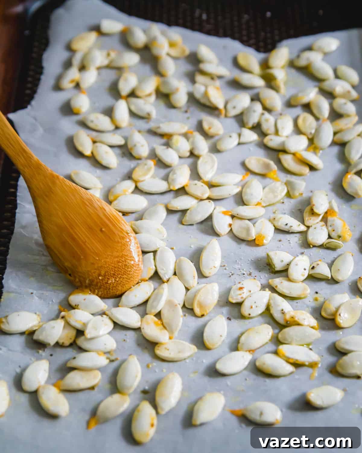 Squash seeds cleaned, seasoned and ready to be roasted in an oven Squash seeds cleaned, seasoned and ready to be roasted in an oven