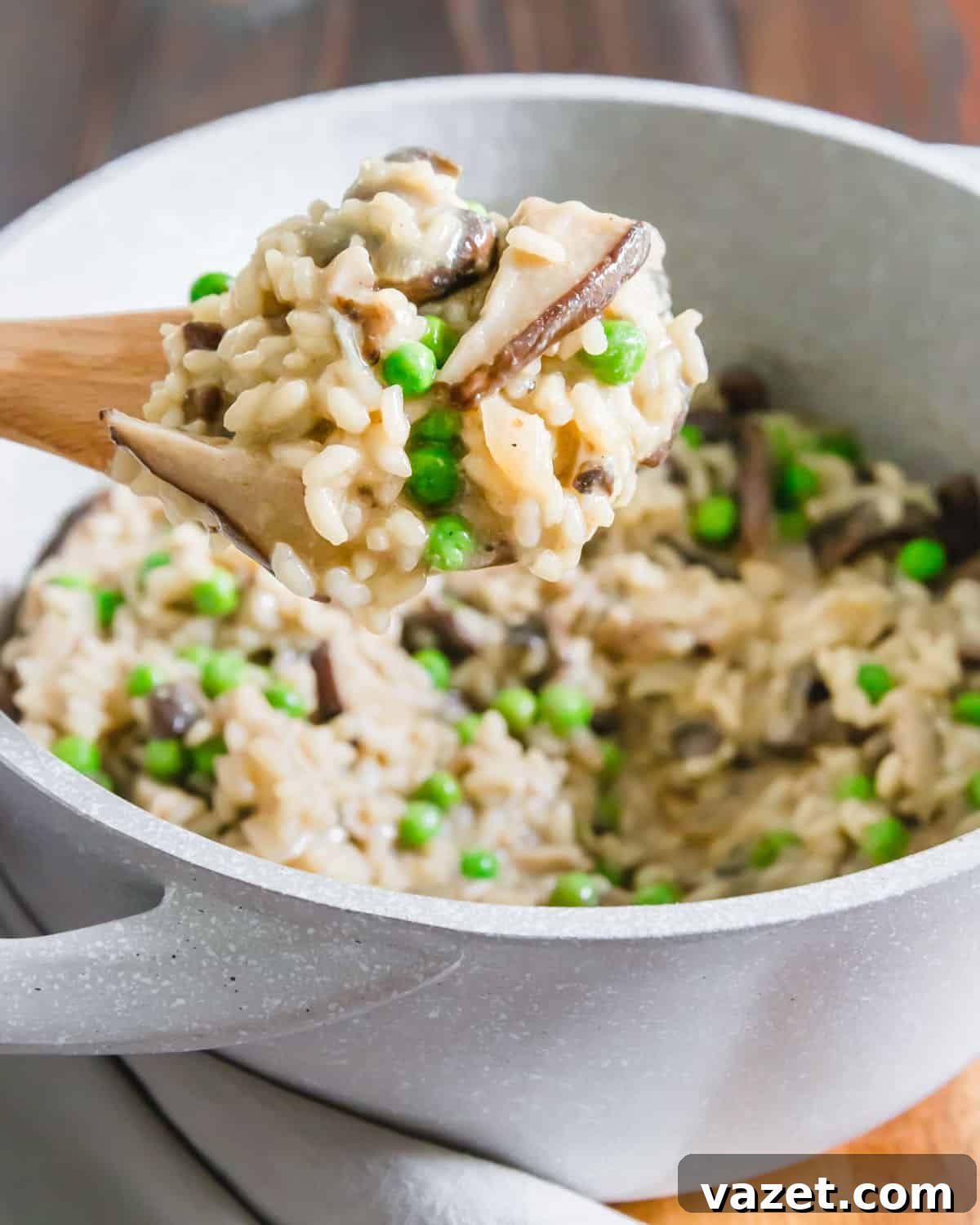 A serving of dairy-free, creamy vegan risotto with mushrooms and peas, captured from above, highlighting its inviting texture and fresh appearance.