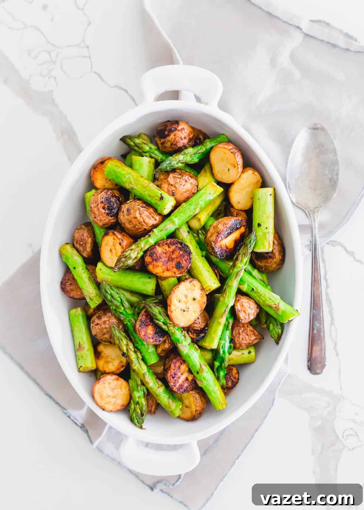 Roasted Potatoes and Asparagus with Garlic Balsamic Roasted potatoes and asparagus on a baking sheet
