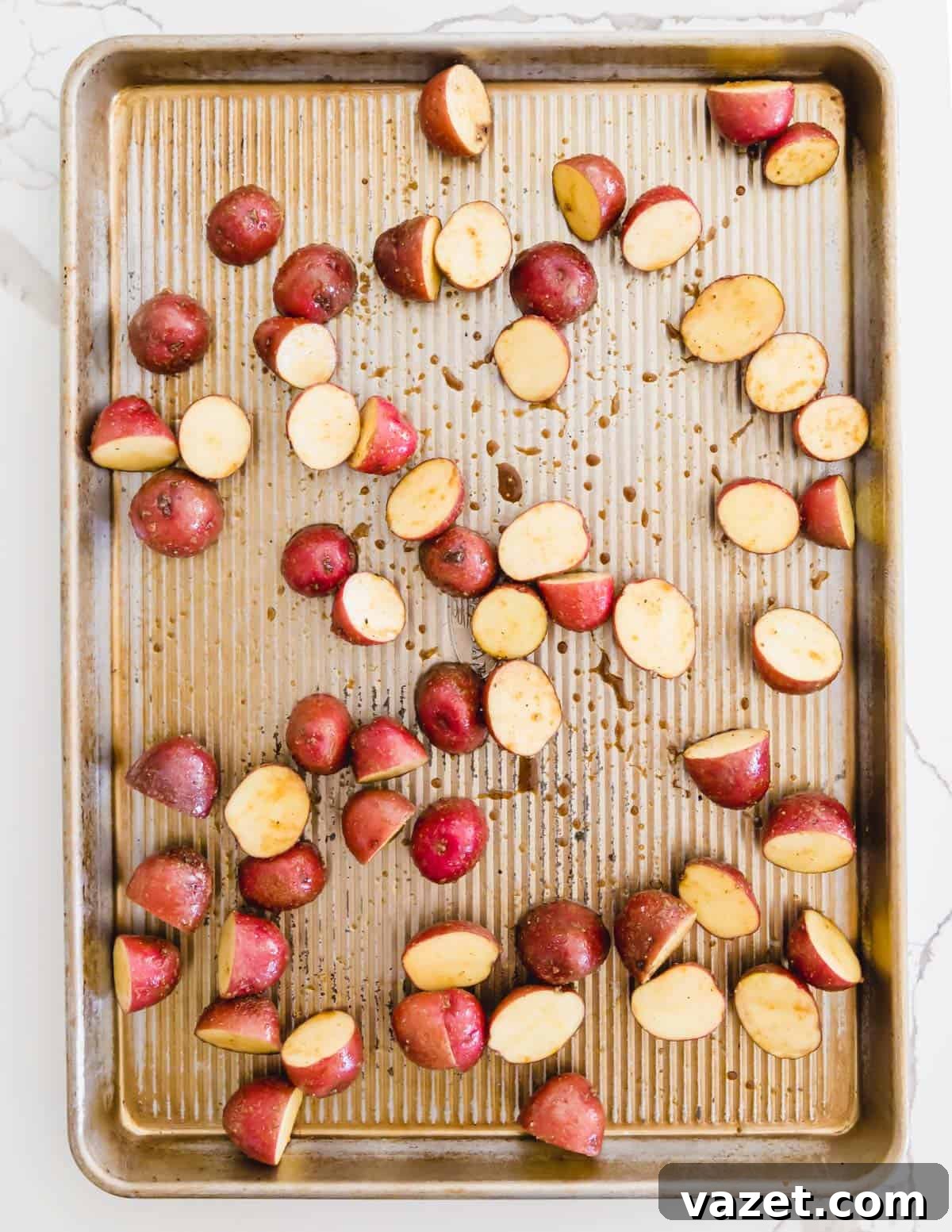 Baby red potatoes on a sheet pan to roast with asparagus Baby red potatoes on a sheet pan ready for roasting with asparagus
