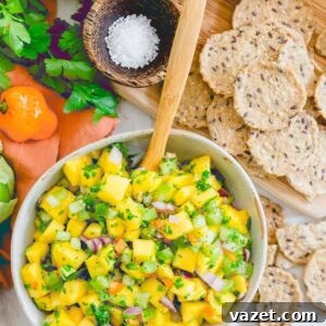 A vibrant bowl of fresh mango habanero salsa, showcasing the delicious chunky texture.